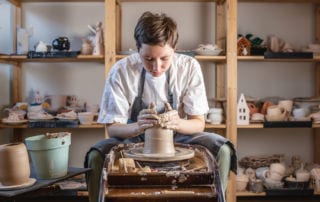 A young potter making a pot