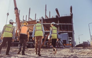 A group of people walking towards a construction site