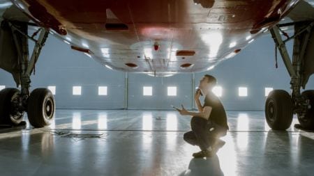 A man examining an airplane