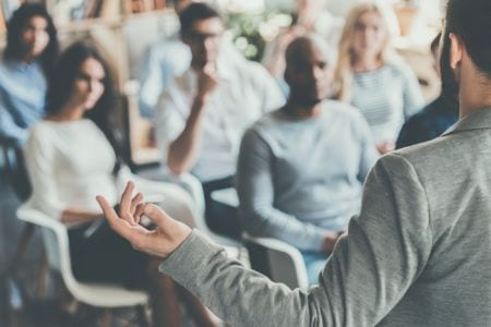 A man giving a talk in front of a group of people