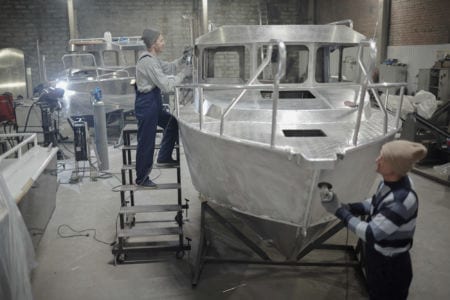 Two men building a boat