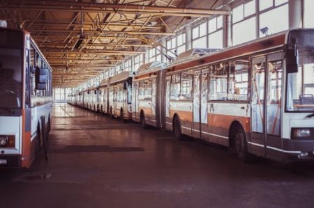 Buses parked in a line in a garage