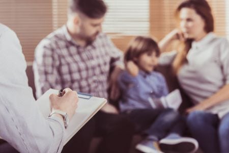 A children, young people and families practitioner interviewing a family