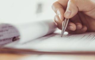 A closeup of a hand signing something