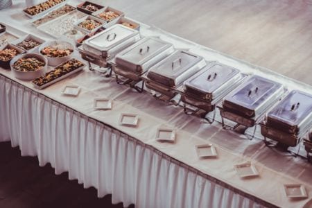 A table laid with food and hotplates