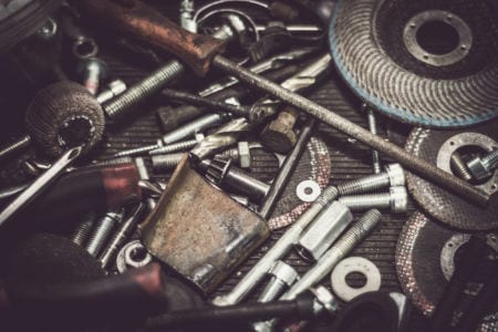 A bunch of screws and tools on a table