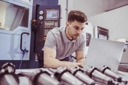 A control tecnical support engineer working at a laptop