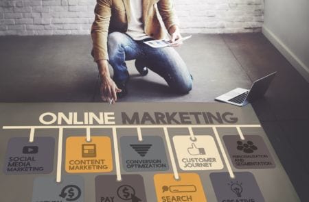 A digital marketer looking at a chart on the floor