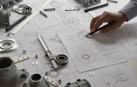 A woman looking at a design on a table