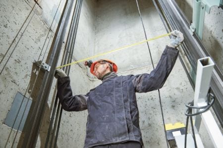 An engineering fitter taking measurements