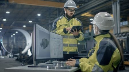 Two engineering manufacturing technicians at work having a conversation