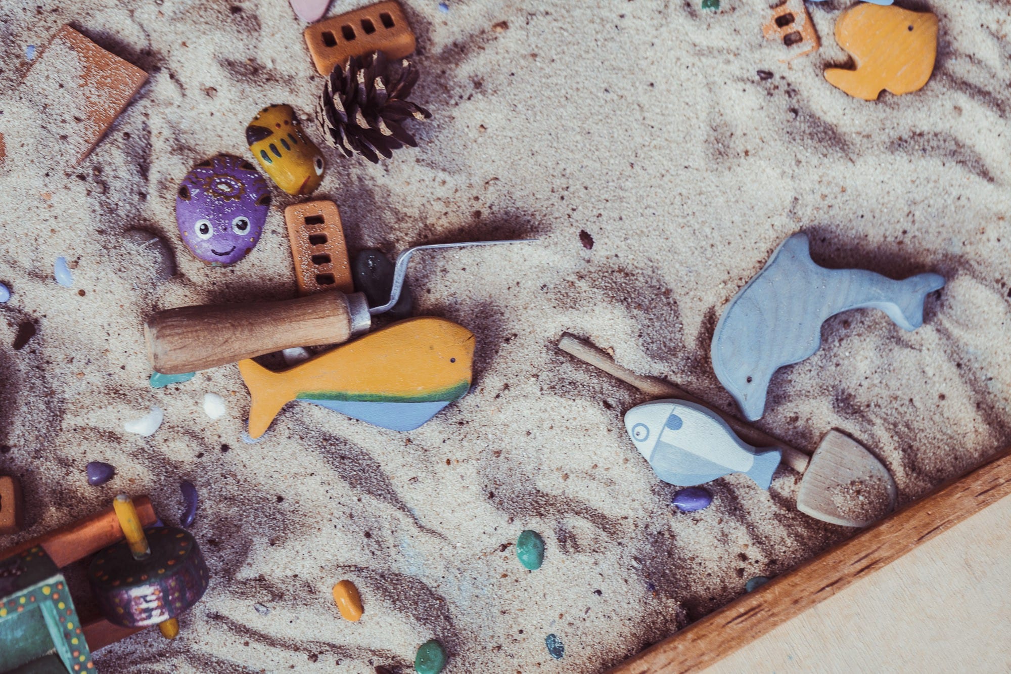 A sandbox filled with toys