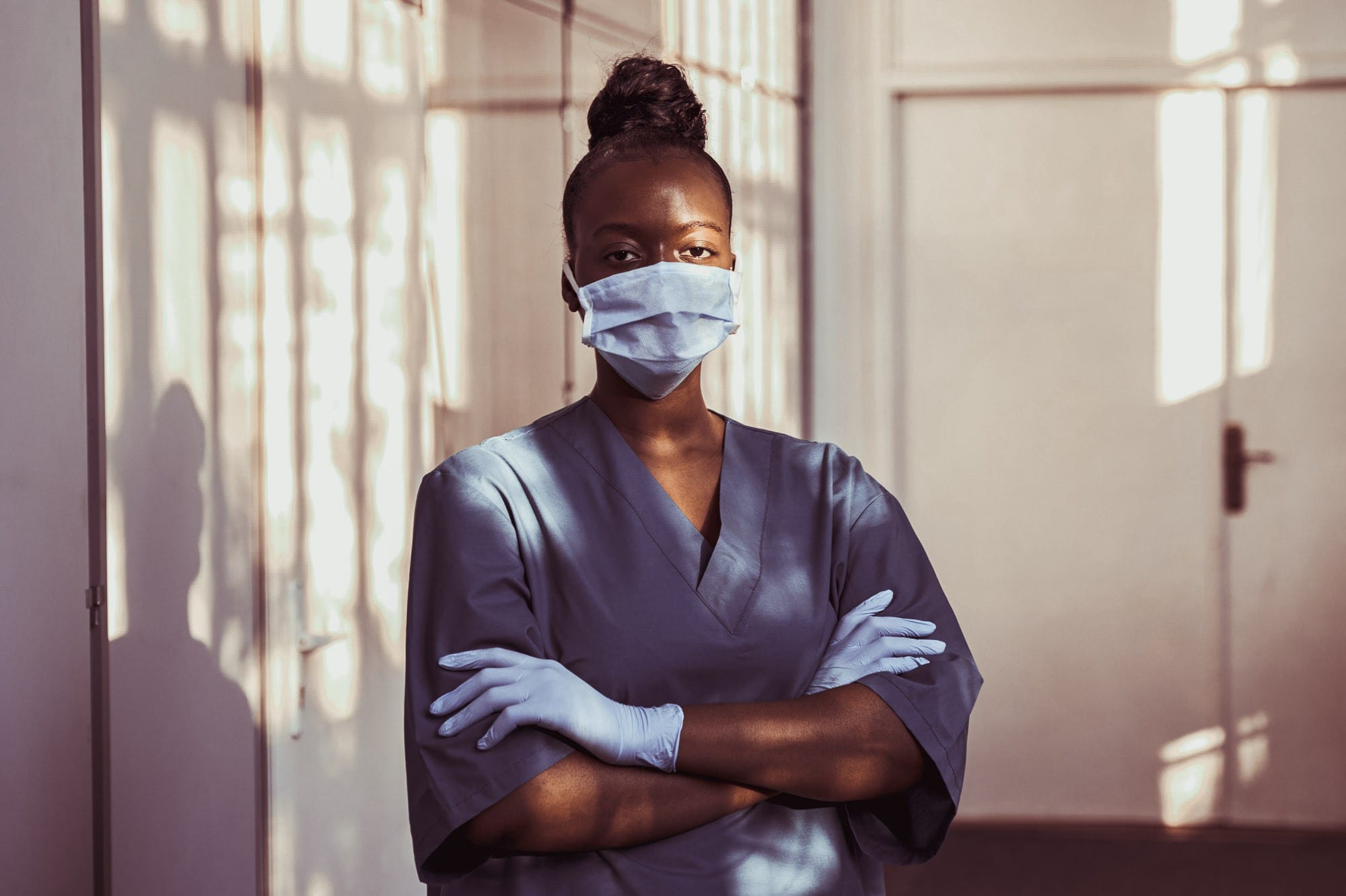 A healthcare assistant practitioner wearing a mask