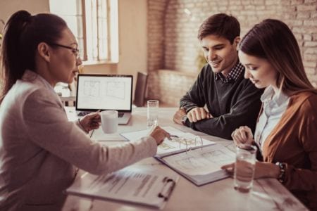 Mortgage advisor talking to a young couple