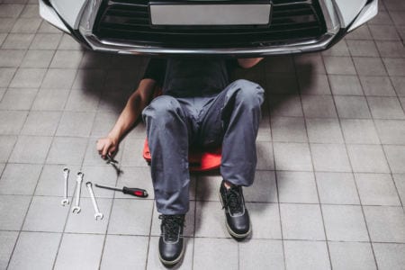 A technician fixing a motor vehicle
