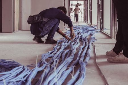A worker installing network cables