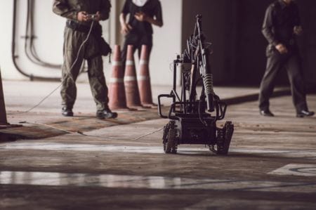 Ordnance munitions and explosives professional controlling a robot