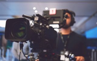 A man working behind a camera