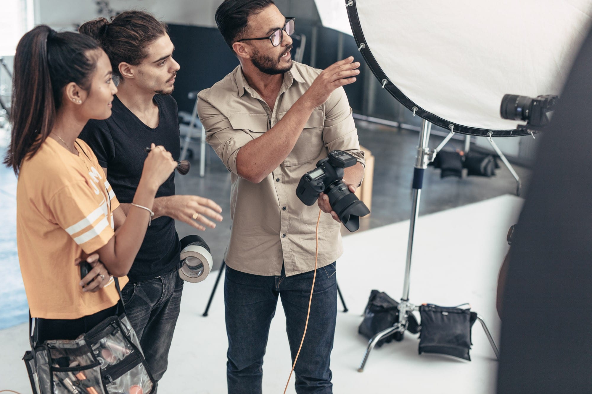 Photographer discussing something with his colleagues