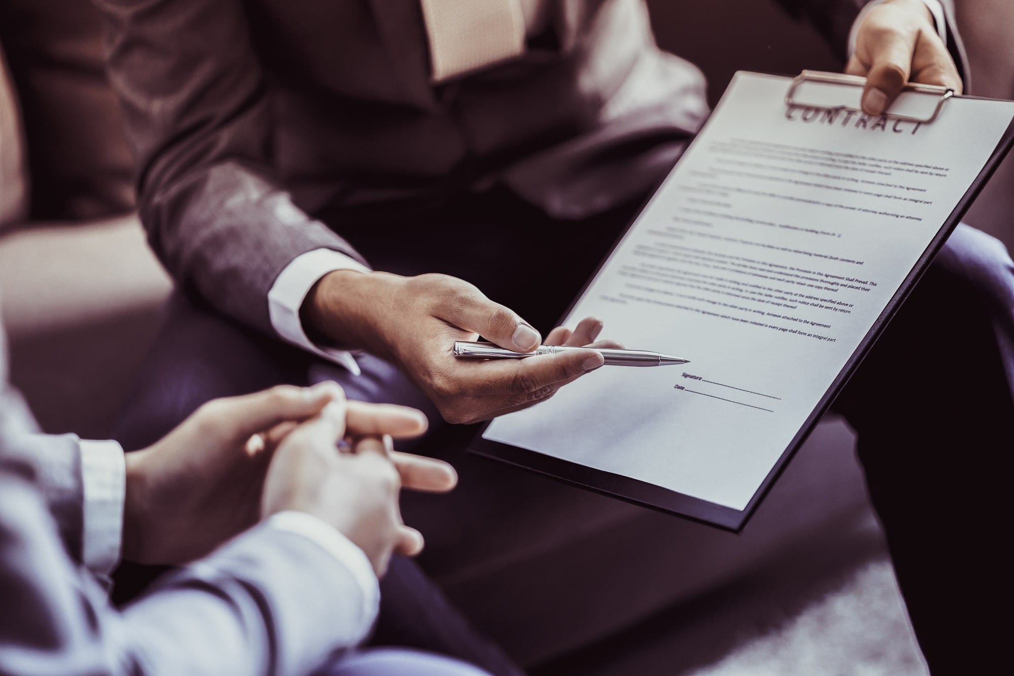 Policy officer holding a contract in front of a client