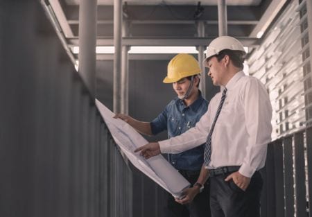 Engineer showing a plan to his colleague
