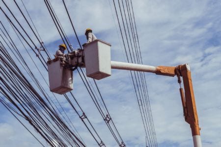 Electricians wiring cables to install and repair power lines