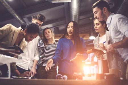 A group of apprentices discussing a project on workforce development