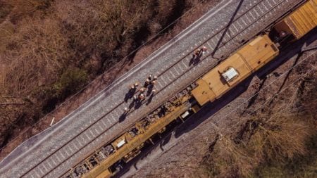 Workers on a railway next to a train