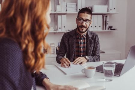 Recruitment consultant talking to a woman in his office
