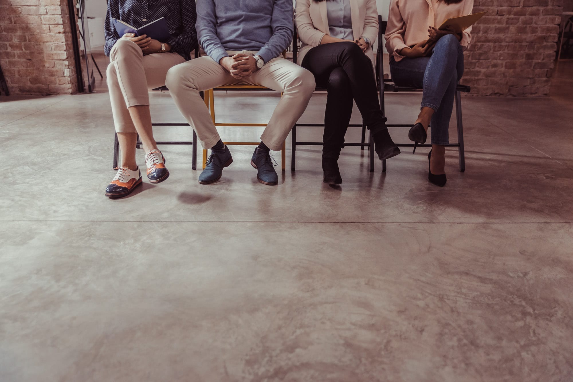 Four people waiting for a job interview