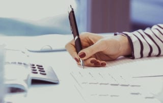 A woman's hand holding a pen