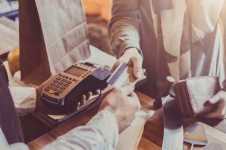 A customer giving their credit card to a cashier