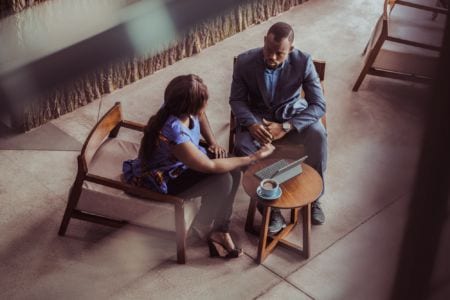 A man and a woman talking in a coffee shop
