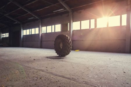 A big tractor tire in an empty warehouse