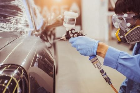A vehicle damage paint technician working