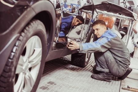A technician checking a car