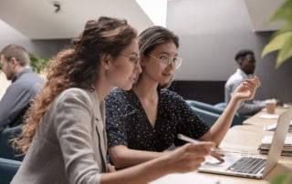 Geospatial Apprenticeships - Two young women looking at a laptop