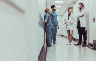 Medical staff having a discussion in a hospital corridor