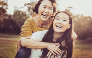 Mother and daughter smiling